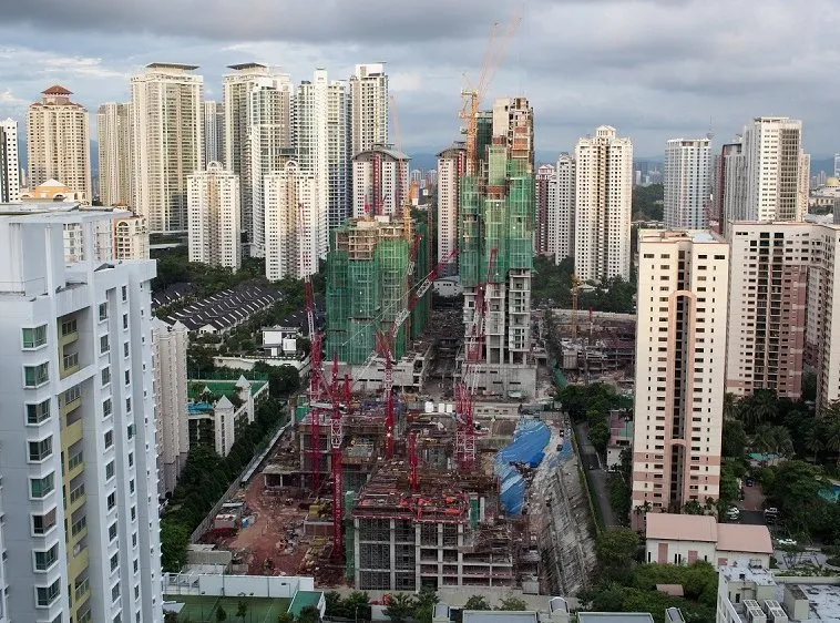 of construction works in Kuala Lumpur, Malaysia shot of construction works in residential area of Kuala Lumpur with high-rise apartment blocks. Clouds sailing over the city and night coming